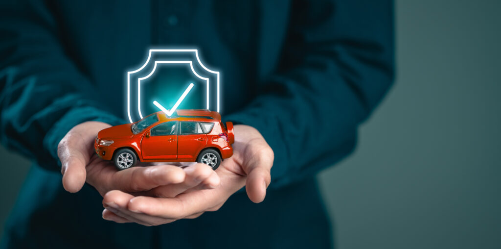assurance, confidence, certificate, certification, guarantee, insurance, protect, security, safety, warranty. A man is holding a toy car with a check mark on it. Concept of security and protection.