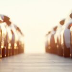 Many cars are neatly parked in rows at a dealership, gleaming under the warm glow of the setting sun, creating a sense of anticipation and choice for potential buyers